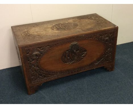 An Edwardian carved camphor wood trunk. Est. £40 - £60.
