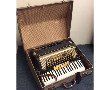 A cased accordion by Scandalli. Est. £30 - £50.
