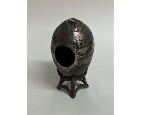 An unusual engine turned silver egg on stand. London. Approx. 68 grams. Est. £30 - £40.