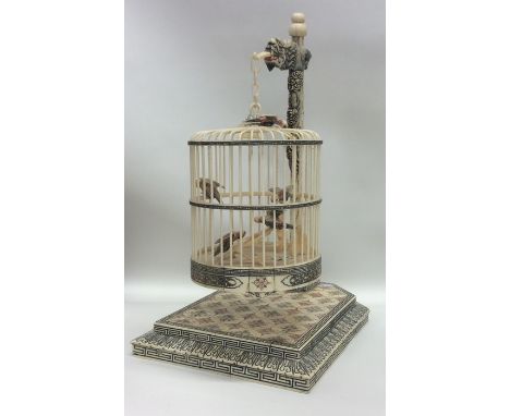An unusual Antique ivory model of a birdcage with matching stand and suspension chain to fitted interior and dragon mount. Ap