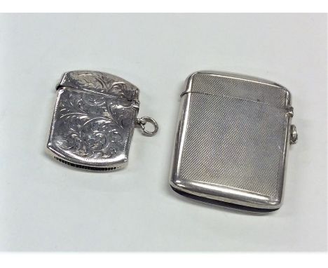 A heavy silver engine turned vesta case together with one other. Approx. 77 grams. Est. £30 - £50.