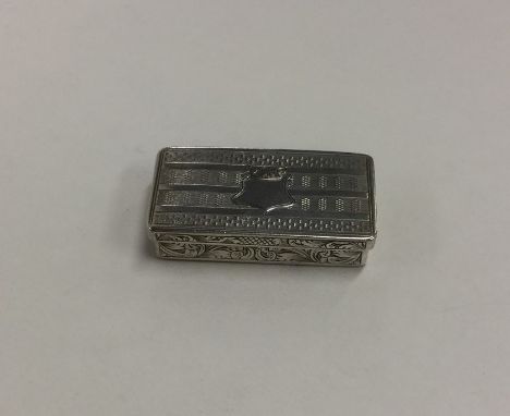 A Georgian silver hinged top vesta case / snuff box with engine turned decoration. Approx. 23 grams. Est. £50 - £80.