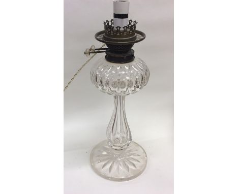 A good glass oil lamp base on spreading foot. Est. £200 - £300.