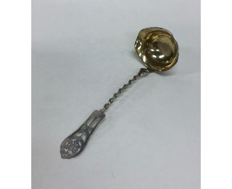 A Russian silver cream ladle with twisted stem and gilt bowl. Approx. 23 grams. Est. £40 - £60.