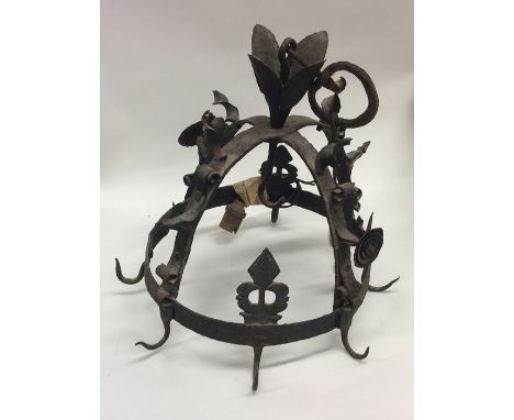 An unusual cast iron Medieval style wall hanging on suspension chain. Est. £30 - £50.