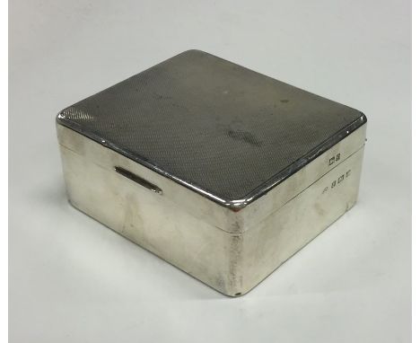 A silver engine turned hinged top cigarette box. Birmingham. By A Bros. Approx. 287 grams. Est. £40 - £60.