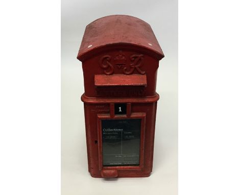 A Georgian domed top Royal Mail 'G R' red cast iron letter box with hinged front. Approx. 52 cms x 24 cms. Est. £150 - £200.