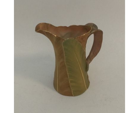 A small attractive Royal Worcester cream jug with leaf decoration. Est. £25 - £35.