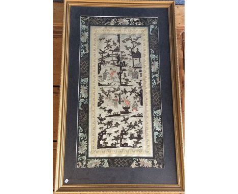 A framed and glazed sampler of Oriental design. Approx. 63 cms x 33 cms. Est. £30 - £50.