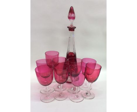 A set of eight cranberry glasses together with a decanter. Est. £20 - £30.
