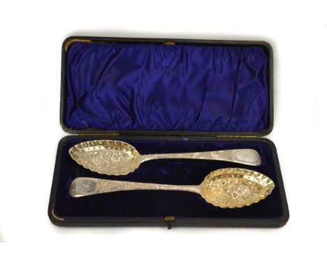 A pair George III boxed silver berry spoons, with reposse and engraved gilded floral bowls. 'R' initial on handles. [London 1