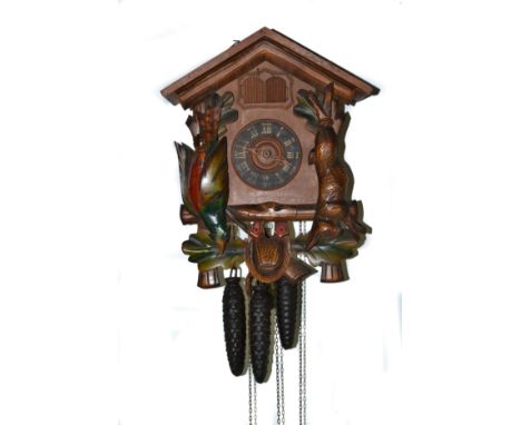 Vintage hunting lodge cuckoo clock having carved pheasant and rabbit detail