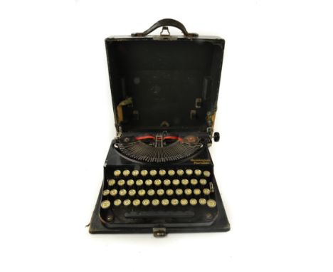 Vintage Remington portable typewriter in original case.