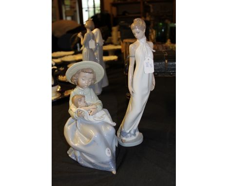 Two Nao figures including girl with baby