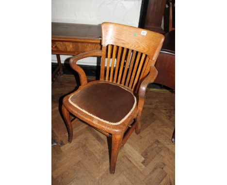 George V light oak smokers chair with double stretcher, upholstered with marks to underside
