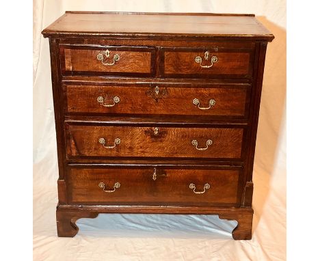 An early George III and later oak and mahogany crossbanded chest of drawers, circa 1760, slight oversailing top above two sho