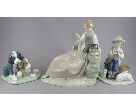 A group of three Nao porcelain figure groups. To include: a boy shepherd piping, two dogs and a seated reading woman. Factory