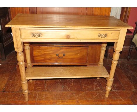 An early twentieth century pine table, two drawers and a shelf. 91cm wide.&nbsp;
