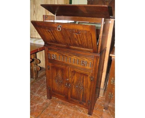 An early twentieth century oak drinks cabinet with drop front and with glass shelf etc. 75cm wide 123 tall