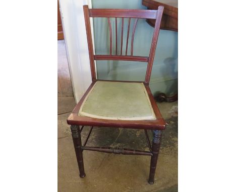 A nineteenth century mahogany child's chair with green upholstered seat and inlayed frame. Turned bobbin-type stretchers. 74 