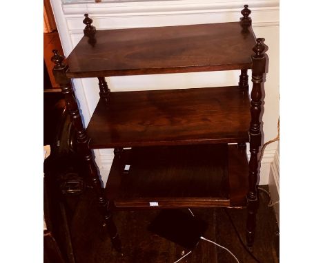 An Edwardian mahogany serving trolley, circa 1905, rectangular form mounted with turned globe finials, over turned supports, 