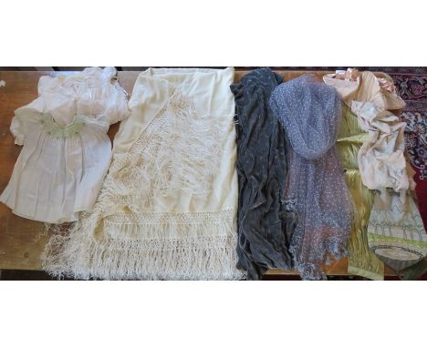 A collection of textiles to include a large cream piano shawl 1920s in fine wool with silk tassels and embroidered floral des