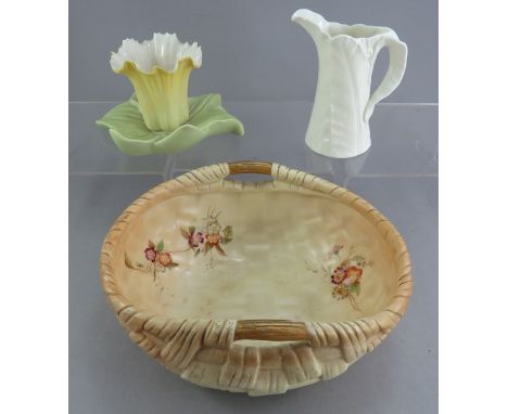 A group of early twentieth century Worcester porcelain pieces to include: A Blush Ivory basket, a leaf-moulded jug and a Grai