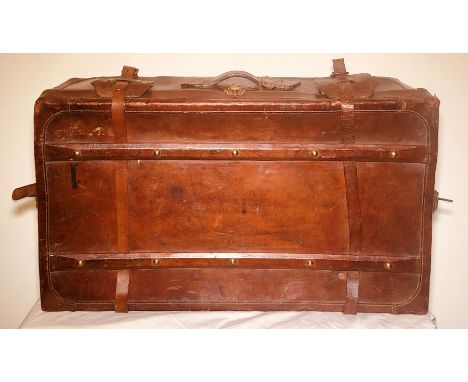 An early 20th century French leather travelling trunk suitcase, brass locks engraved with "Surete", leather stitching hinge l