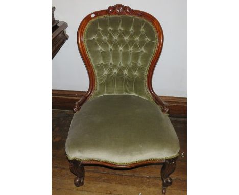 A Victorian upholstered button back low chair on caster cabriole front feet.&nbsp;&nbsp;