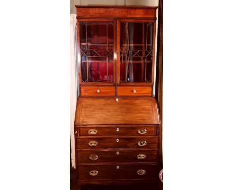 A George III mahogany Bureau Bookcase, Circa 1820 moulded cornice satinwood strung inlay on a continuing fluted cornice, to p