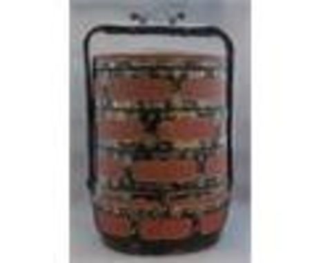 An oriental black lacquer four section lidded storage container, of cylinder form, swing handle, simulated rattan panels, hei
