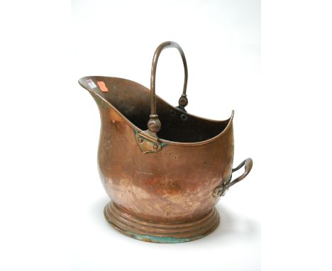 A copper helmet shaped coal scuttle 