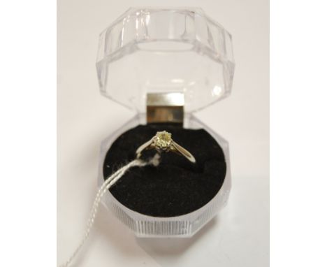 A white metal diamond solitaire ring, the old brilliant weighing approx 0.3ct