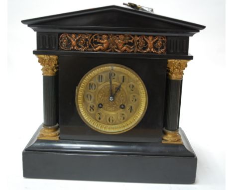 A late 19th century black slate mantel clock of architectural outline, having striking movement 