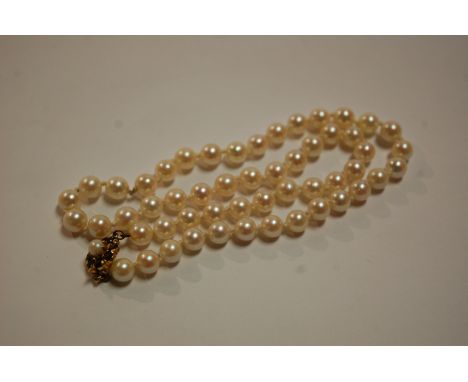 A cultured pearl single string necklace having 9ct gold and garnet set clasp 