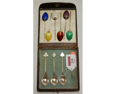 A set of six silver and guilloche enamel backed coffee spoons; and a cased set of three silver spoons, the terminals as playi