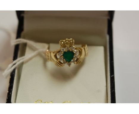 A modern 9ct gold emerald and diamond set ring