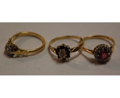 An 18ct gold diamond solitaire ring, 9ct gold sapphire and diamond flower head cluster ring, and one other (3)