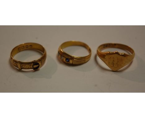 An 18ct gold gents signet ring, 18ct gold belt ring, and an 18ct gold sapphire and diamond set dress ring, gross weight 12.5g