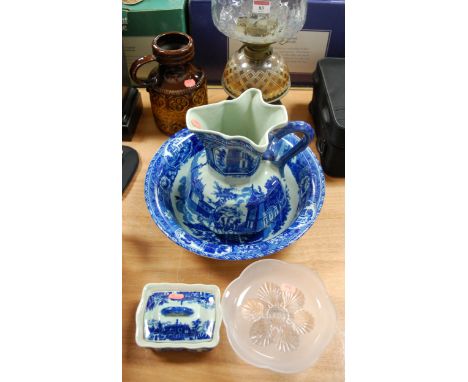 A late Victorian brass and cut glass pedestal oil lamp; a mid-20th century German studio pottery jug; and a reproduction blue