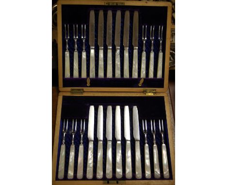 A cased twelve place setting mother of pearl handled dessert knives and forks; together with an oak canteen of fish knives an