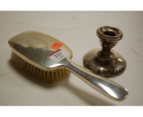 A silver backed hairbrush, and a silver dwarf candlestick (a/f) (2)
