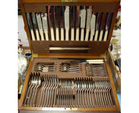 A mid-20th century walnut cased eight place setting cutlery canteen, one table fork missing otherwise complete and very littl