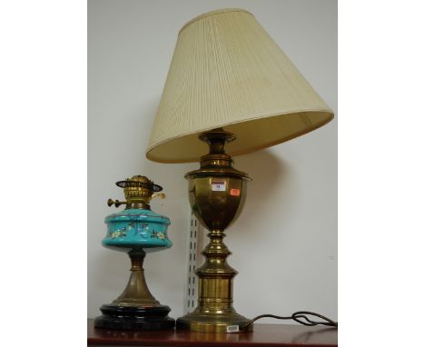 A reproduction brass table lamp; and a circa 1900 lacquered brass and blue glass pedestal oil lamp (2)