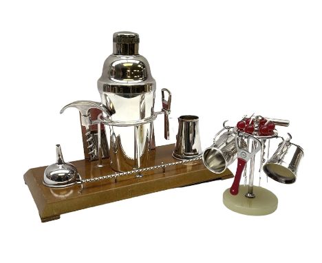 Mid 20th century Art Deco style silver plated cocktail set comprising shaker and cover, funnel, twisted spoon, corkscrew, bot