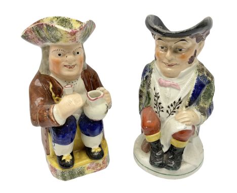 Mid 19th century pearlware Toby jug, modelled seated with a jug and pipe with spongeware decorated tricorn hat, raised upon a