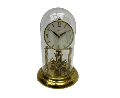 A mid-20th century “Bentima” 400-day anniversary torsion clock with a 7” circular brass base and unenclosed movement supporte
