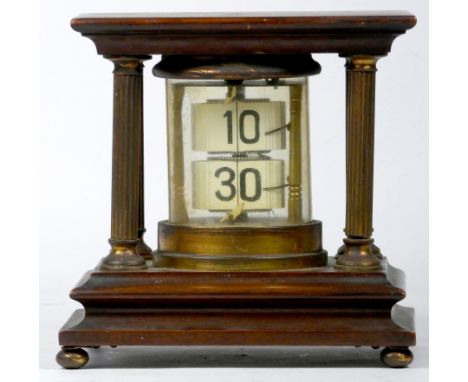A mahogany and brass 'Ticket' desk clock, of cylindrical form, housed by four reeded brass pillars on a stepped base with bun