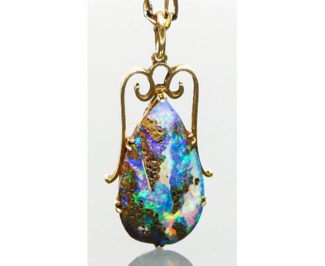 A yellow gold mounted pear shape black boulder opal pendant, 25 x 14mm, to a later 9ct gold 48cm chain, chain 6.5gm.Condition