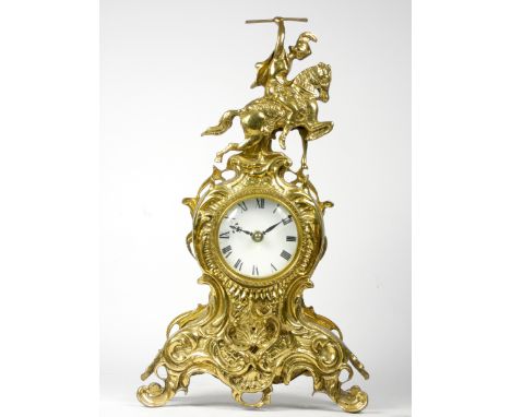 An early 20th century Ormolu style mantel clock, scroll and floral decorated gilt metal case, white enamelled dial with Roman